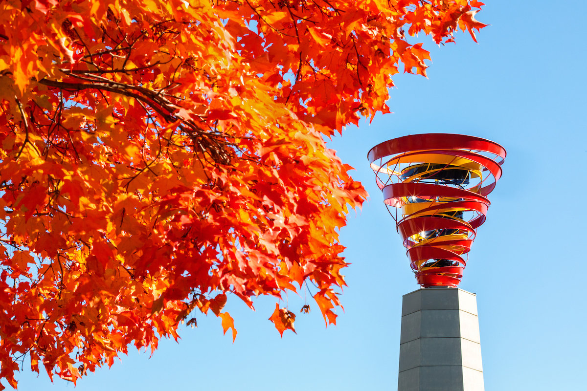 Fall tree leaves with cyclone statue