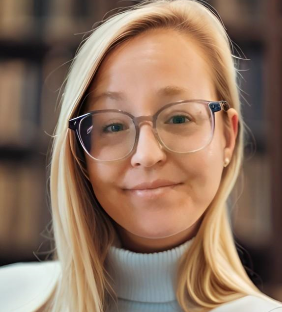 A picture of Molly with blonde hair, wearing glasses and a light blue turtle neck sweater. 