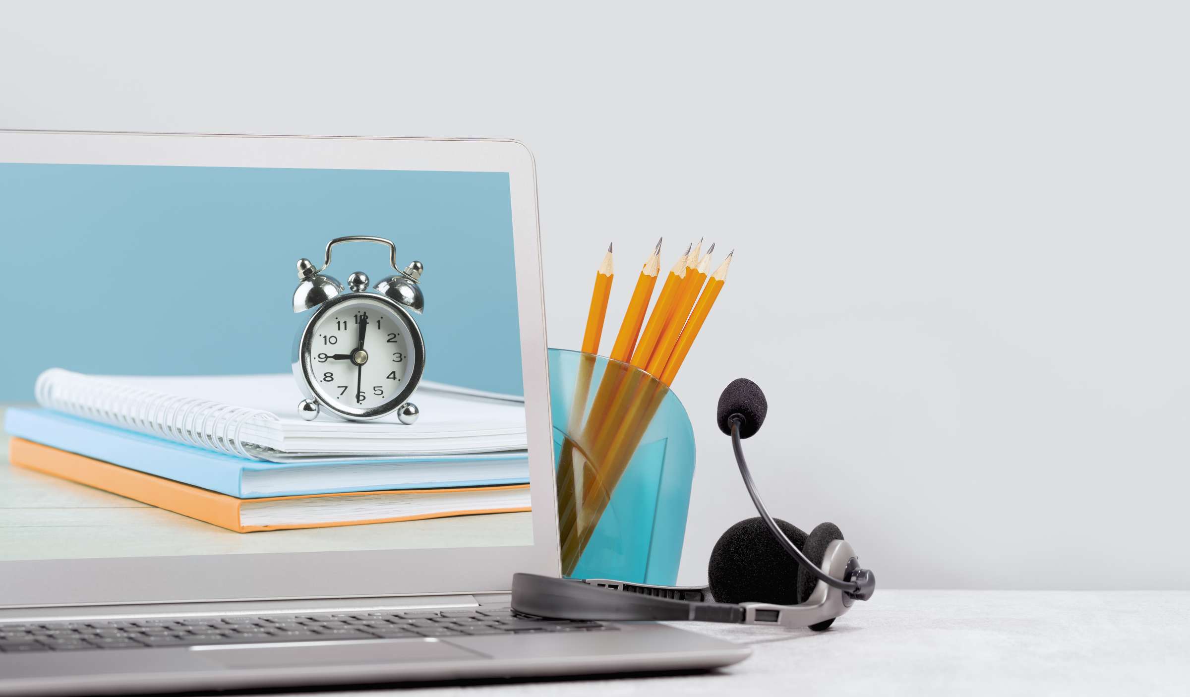 Photo of computer and testing materials including pencils and a clock