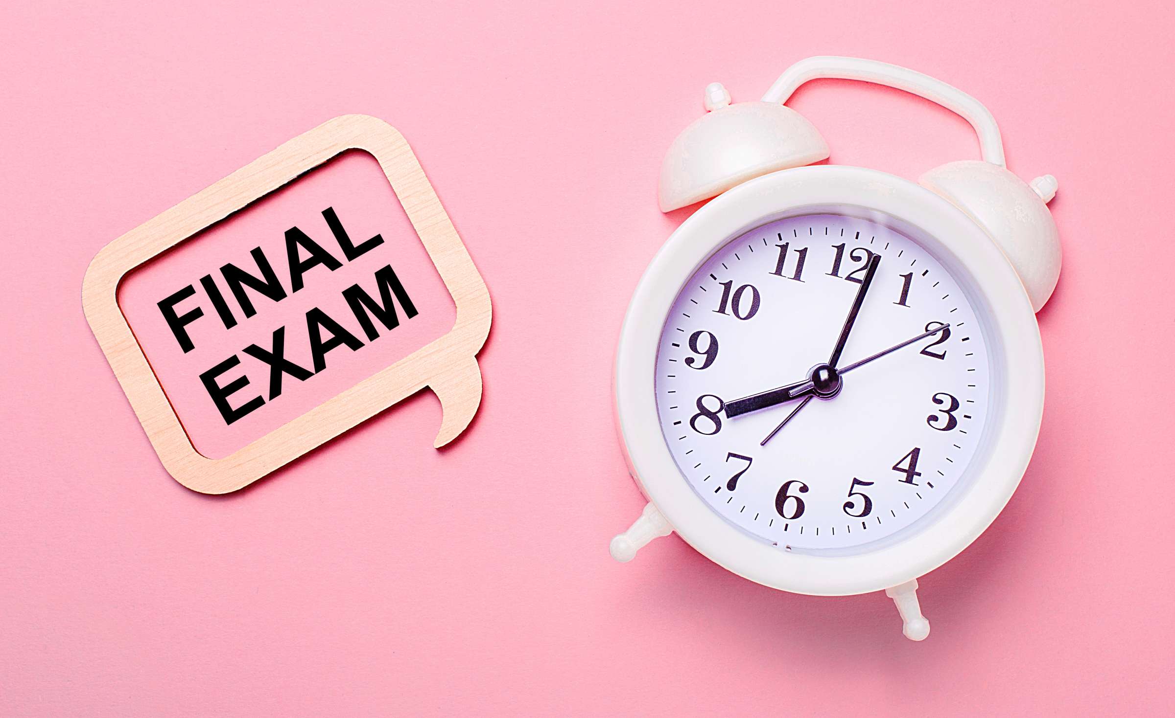 A pink clock on a pink background with a thought bubble saying final exam