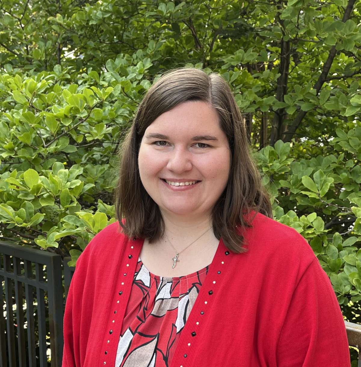 Photo of coordinator Jalissa with medium length dark hair wearing red