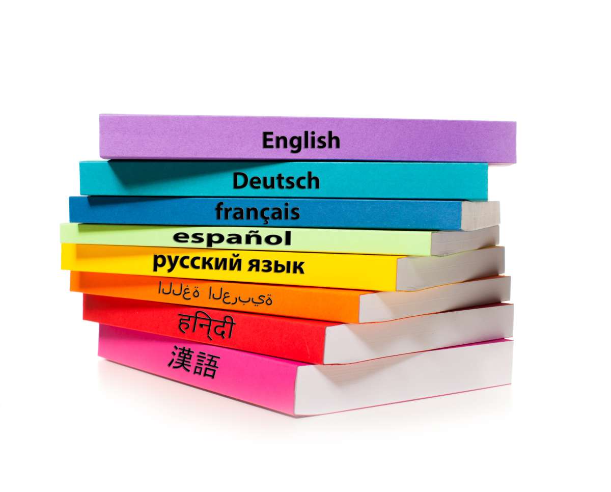 A stack of colorful books with different languages written on the spines